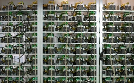 FILE PHOTO: Cryptocurrency miners are seen on racks at the HydroMiner cryptocurrency farming operation near Waidhofen an der Ybbs, Austria April 25, 2018.   REUTERS/Leonhard Foeger/File Photo