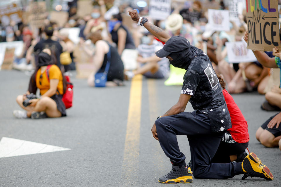 Jemel Black and his 11-year-old daughter, Tyarah, kneel June 6 with other protesters in Great Barrington, Massachusetts, for 8 minutes and 46 seconds, the amount of time that George Floyd was pinned to the ground with a white police officer's knee on his neck. (Photo: Stephanie Zollshan/The Berkshire Eagle via Associated Press)