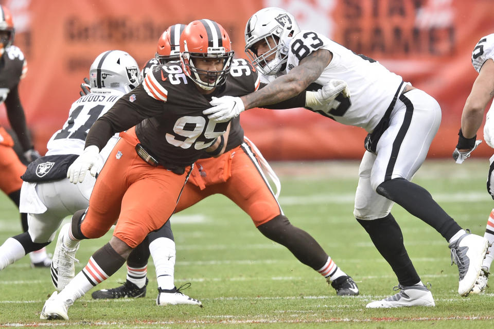 Cleveland Browns defensive end Myles Garrett (95) runs around Las Vegas Raiders tight end Darren Waller (83) during the first half of an NFL football game, Sunday, Nov. 1, 2020, in Cleveland. Garrett injured his knee in the first quarter in the Browns 16-6 loss to the Raiders. (AP Photo/David Richard)