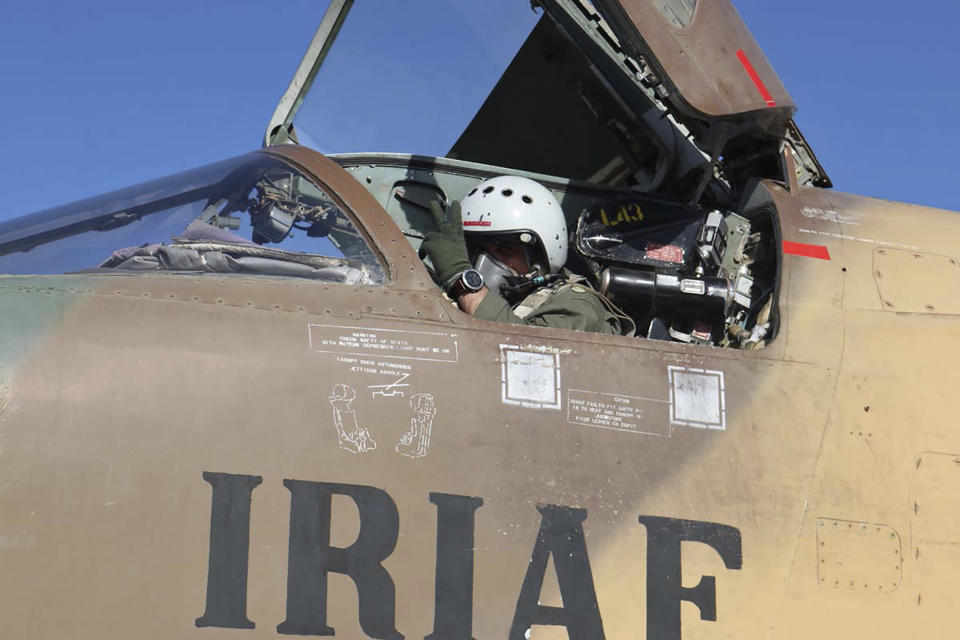 In this picture released by the official website of the Iranian Army, a pilot gestures during an air force exercise, in Iran, Thursday, Oct. 21, 2021. Iran on Thursday kicked off an annual air force drill across the country, a week after holding another massive exercise in air defense, state TV reported. (Iranian Army via AP)