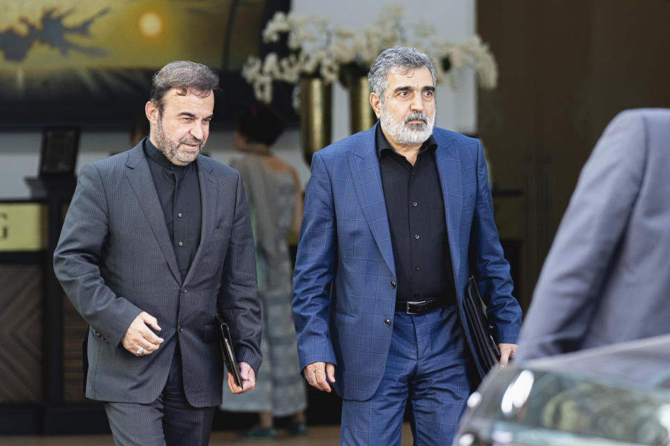 Iranian deputy foreign minister Reza Najafi, left, and Iranian AEOI spokesperson Behrouz Kamalvandi, right, are leaving the Palais Coburg where closed-door nuclear talks take place in Vienna, Austria, Friday, Aug. 5, 2022. A new round of talks on the revival of the Joint Comprehensive Plan of Action (JCPOA) began in Vienna on Thursday. (AP Photo/Florian Schroetter)