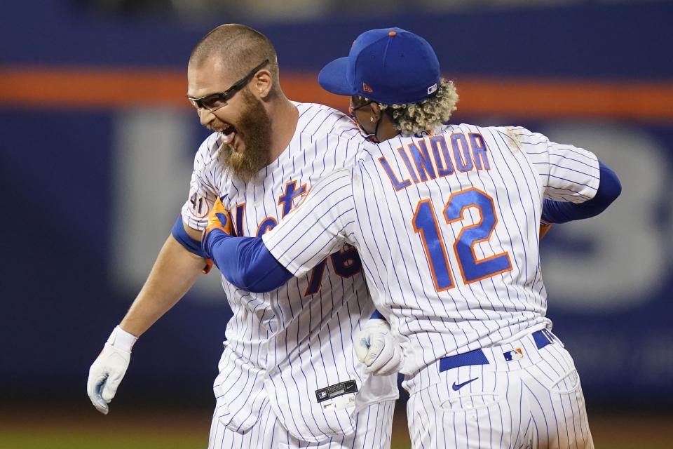 New York Mets' Francisco Lindor, right, celebrates with Patrick Mazeika after the team's baseball game against the Baltimore Orioles on Tuesday, May 11, 2021, in New York. The Mets won 3-2. (AP Photo/Frank Franklin II)