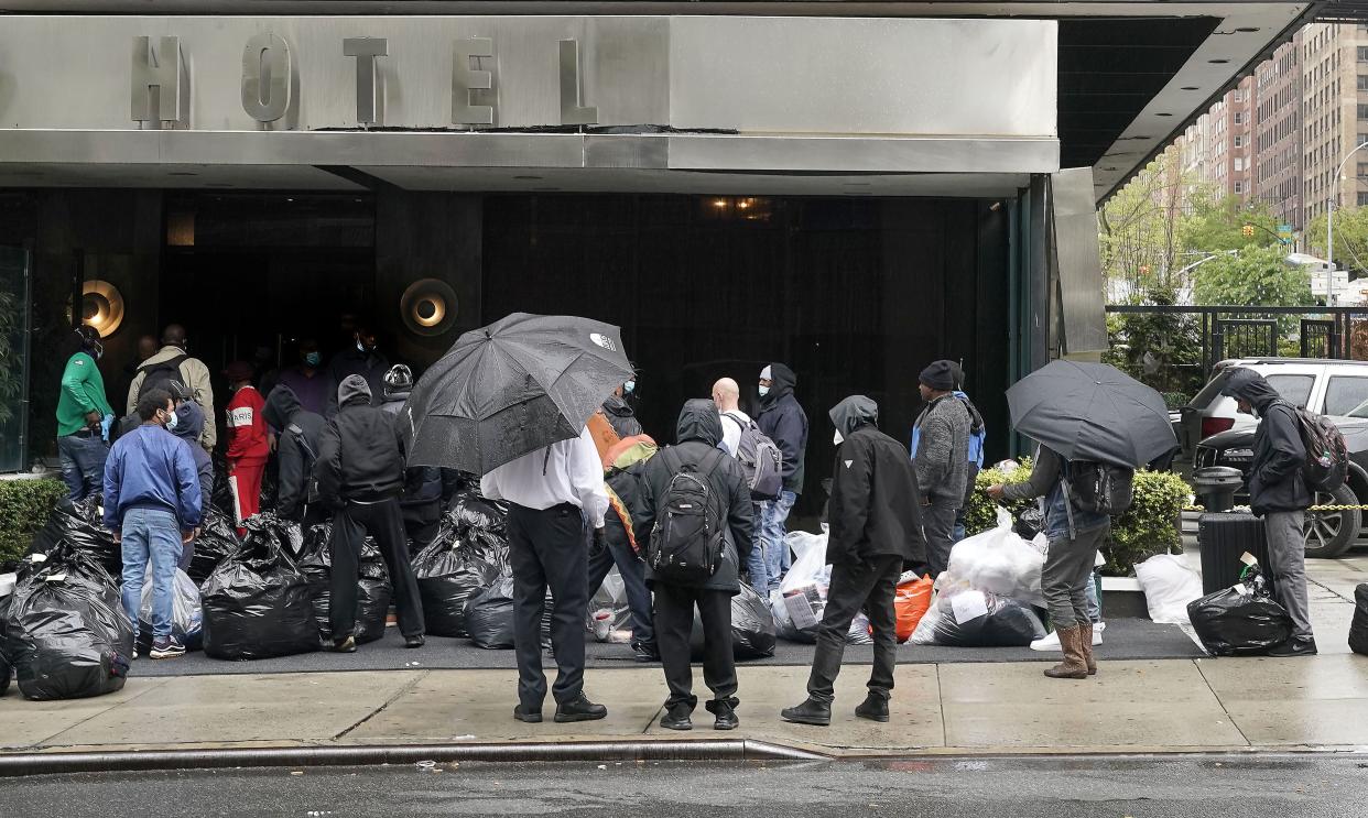 Homeless men line up to check into the Bentley Hotel on E. 63rd St. in Manhattan, New York. 