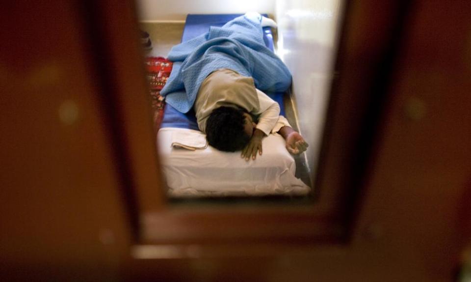 A detainee sleeps on a mattress on the floor in Camp 5 of the Guantánamo detention facility in Cuba in 2008.