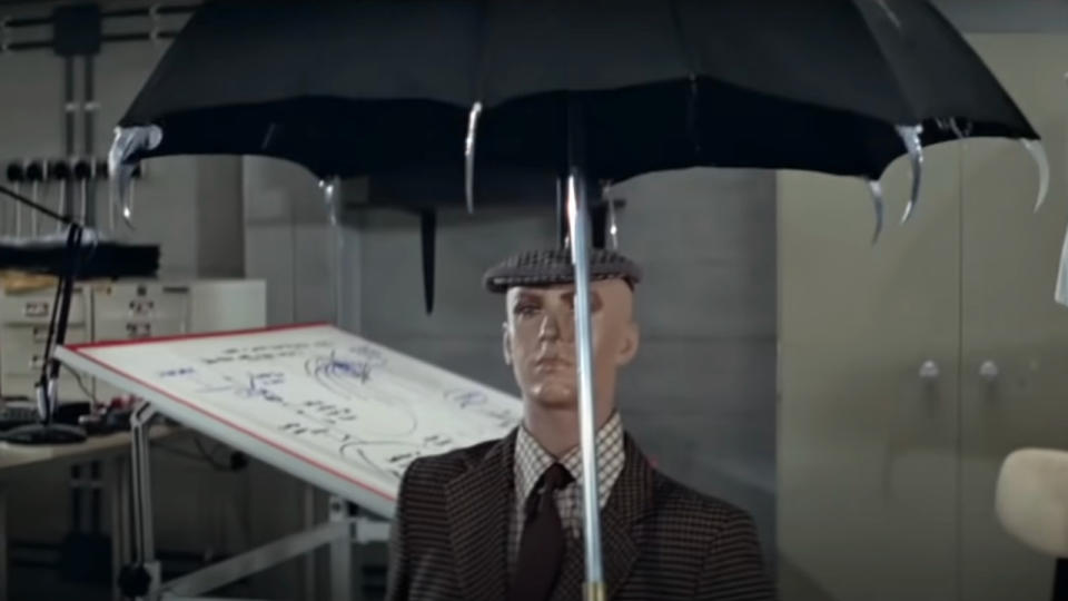 The spiked umbrella gadget, held above a test dummy, in For Your Eyes Only.