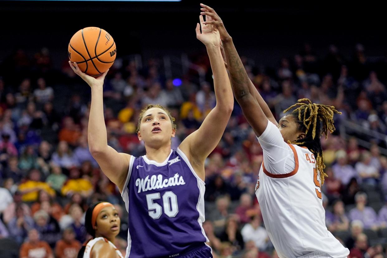 Kansas State center Ayoka Lee (50) shoots over Texas' DeYona Gaston, right, during Monday's Big 12 Tournament semifinal game at T-Mobile Center.