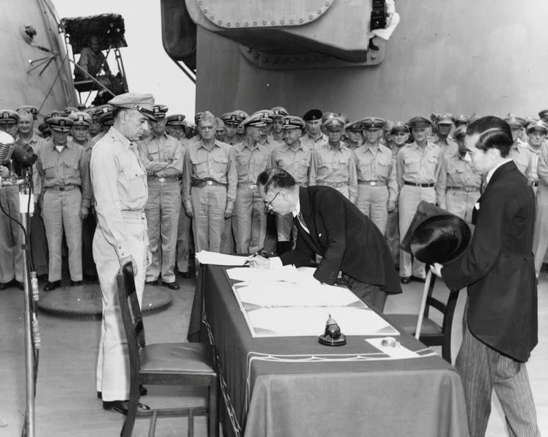 FILE PHOTO: Japan's Foreign Minister Mamoru Shigemitsu signs the Instrument of Surrender onboard the U.S. Navy battleship USS Missouri in Tokyo Bay