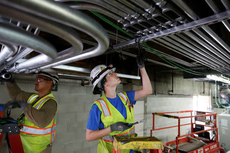 International Brotherhood of Electrical Workers Local 11 union electrician Hannah Cooper, 28, works on a project site in Los Angeles, California, United States, June 21, 2016. REUTERS/Lucy Nicholson