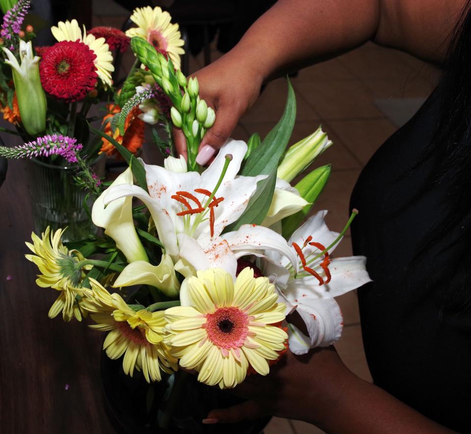 Starting with a basic arrangement of bigger flowers to get a flow going, foral designer Keanna Banks of Brockton gradually adds more to augment the design, depending if she wants a symetrical design or asymetrical design. Tuesday, may 2, 2023.