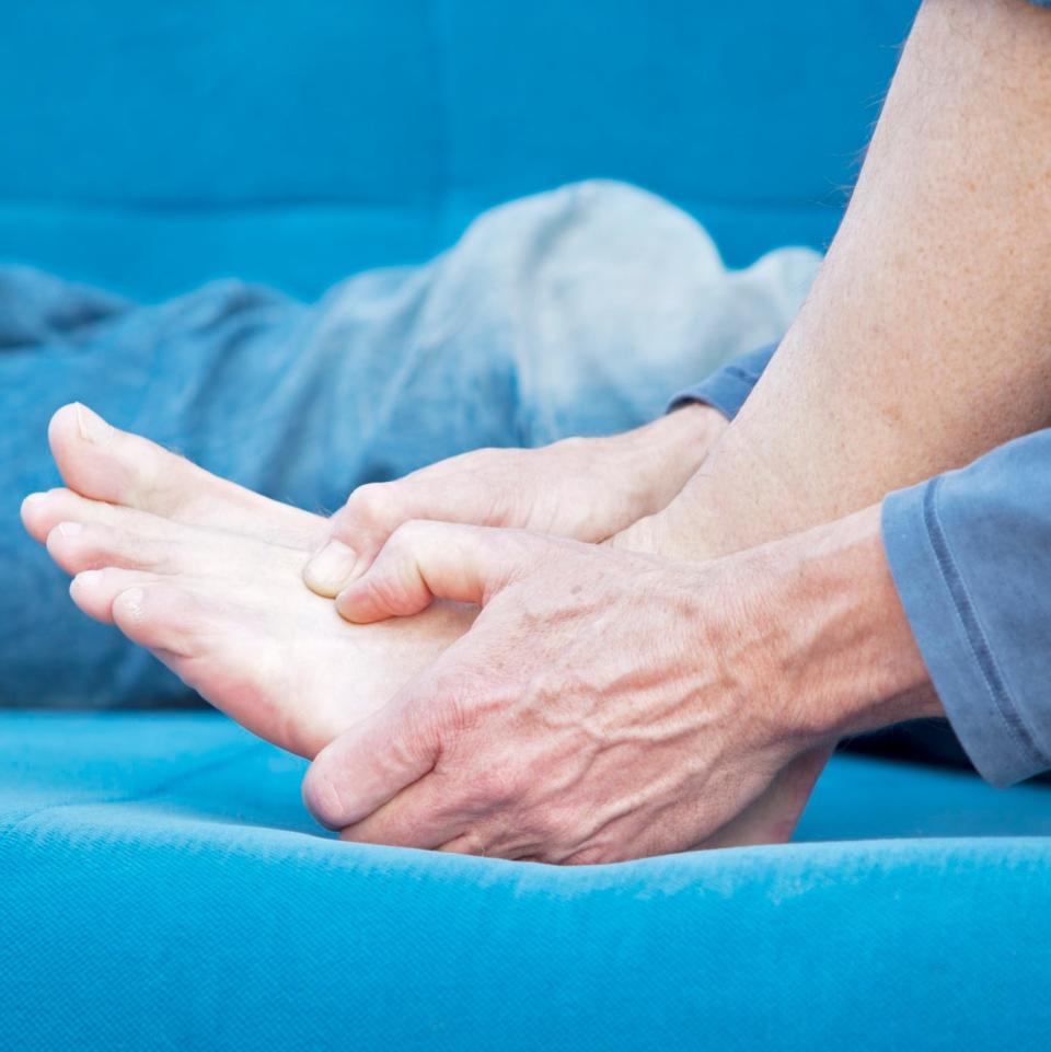 A person massaging his foot