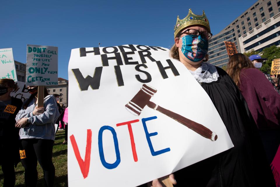 People rally during the Women's March at Freedom Plaza, Saturday, Oct. 17, 2020, in Washington. (AP Photo/Jose Luis Magana)