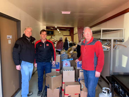 U.S. Governor of Nebraska Pete Ricketts, U.S. Senator Ben Sasse (R-NB), pose for a photo after a storm triggered historic flooding in Lynch, Nebraska, U.S. March 16, 2019. Office of Governor Pete Ricketts/Handout via REUTERS