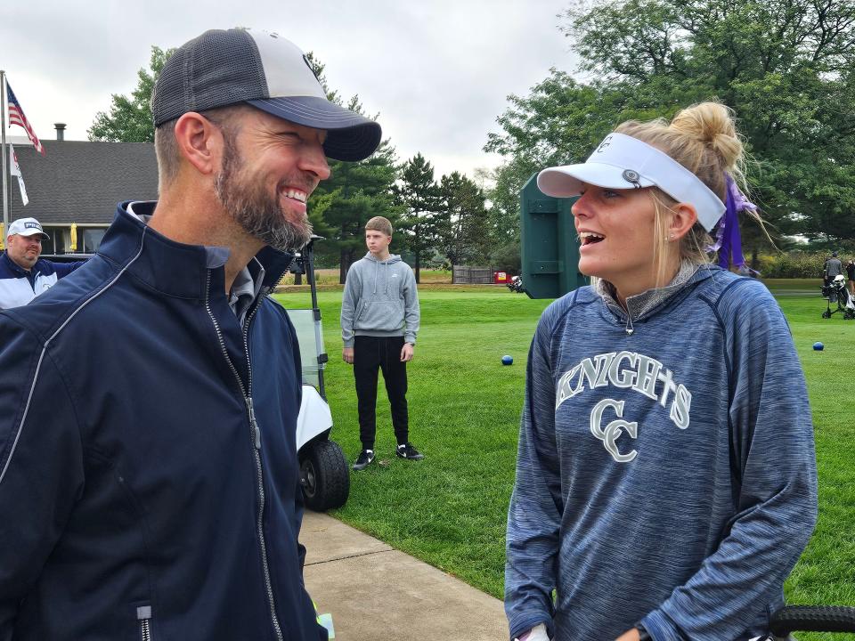 Central Catholic senior Sophie Royer (right) talks pregame strategy with her coach Jackson Bogan (left) before the start of the IHSAA girls golf regional championship at Battle Ground Golf Club in Battle Ground, Ind. on Saturday, Sept. 28, 2024.