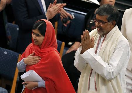Nobel Peace Prize laureates Malala Yousafzai (L) and Kailash Satyarthi arrive for the Nobel Peace Prize awards ceremony at the City Hall in Oslo December 10, 2014. REUTERS/Suzanne Plunkett