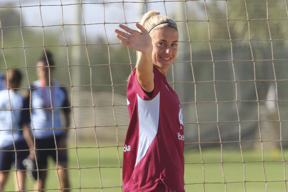 Spain's Alexia Putellas waves to fans during a national team players training session in Oliva, Spain, Wednesday, Sept. 20, 2023. Most of Spain's World Cup-winning players have ended their boycott of the women's national team after the government intervened to help shape an agreement that was expected to lead to immediate structural changes at the country's soccer federation. (AP Photo/Alberto Saiz)