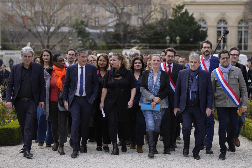 French lawmakers of the far-left group arrive at the National Assembly in Paris, Monday, March 20, 2023. France's government is fighting for its survival Monday against no-confidence motions filed by lawmakers who are furious that President Emmanuel Macron used special constitutional powers to force through an unpopular bill raising the retirement age from 62 to 64 without giving them a vote. (AP Photo/Lewis Joly)