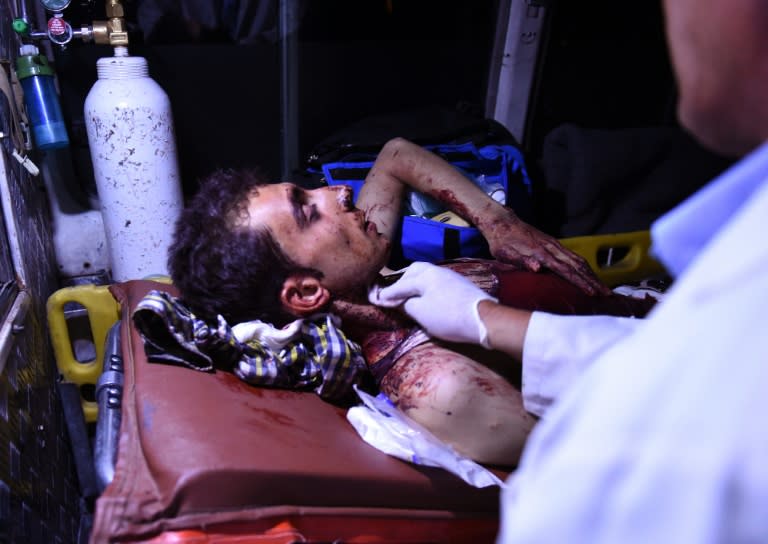 An injured Afghan man lays on a stretcher in an ambulance near the site of an explosion that targeted the elite American University in Kabul, on August 24, 2016