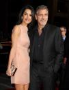 <p>Amal poses with George in a shimmering, soft pink Roland Mouret dress.</p>