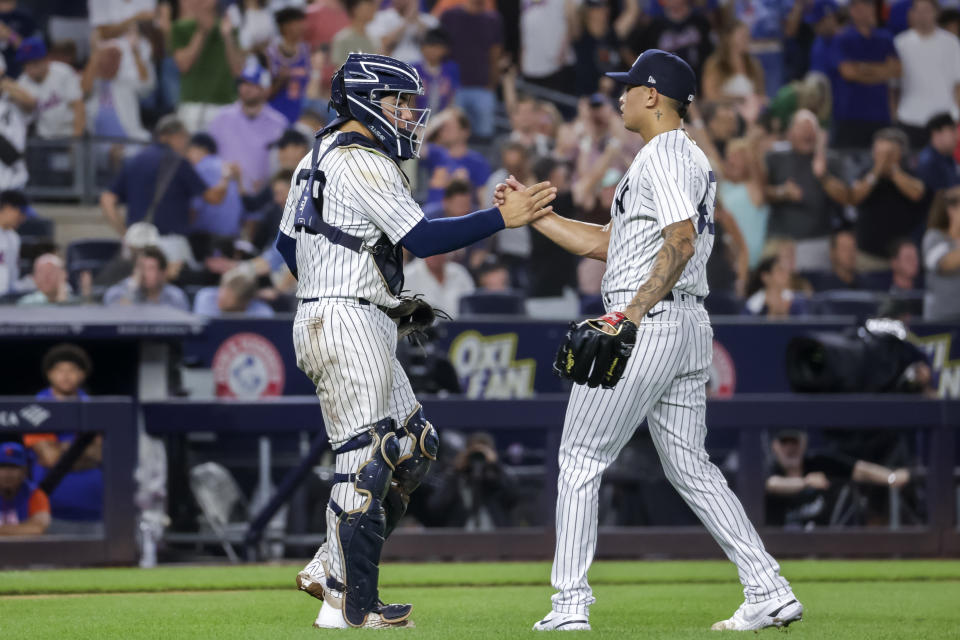 New York Yankees catcher Jose Trevino, left, and relief pitcher Jonathan Loaisiga celebrate their win after a baseball game against the New York Mets, Monday, Aug. 22, 2022, in New York. (AP Photo/Corey Sipkin)