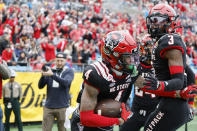 North Carolina State safety Cyrus Fagan (4) and cornerback Aydan White (3) react after Fagan interecepted a Maryland pass during the first half of the Duke's Mayo Bowl NCAA college football game in Charlotte, N.C., Friday, Dec. 30, 2022. (AP Photo/Nell Redmond)