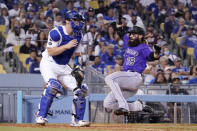 Colorado Rockies' Charlie Blackmon, right, scores on a single by Ryan McMahon as Los Angeles Dodgers catcher Will Smith waits for the ball during the eighth inning of a baseball game Friday, July 23, 2021, in Los Angeles. (AP Photo/Mark J. Terrill)