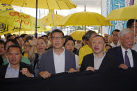 Occupy Central leaders, from left, Lee Wing-tat, Chan Kin-man, Benny Tai and Chu Yiu-ming enter a court in Hong Kong, Wednesday, April 24, 2019. The court is preparing to sentence nine leaders of massive 2014 pro-democracy protests convicted last month of public nuisance offenses. The sentences to be handed down Wednesday are seen as an effort by the government of the semi-autonomous Chinese territory to draw a line under the protests. (AP Photo/Kin Cheung)