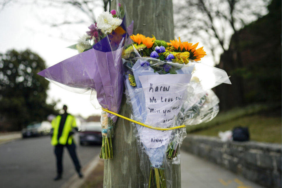 Flowers are secured to a pole as a memorial to Karon Blake, 13, on the corner of Quincy Street NE and Michigan Avenue NE in the Brookland neighborhood of Washington, Tuesday, Jan. 10, 2023. The note reads, 