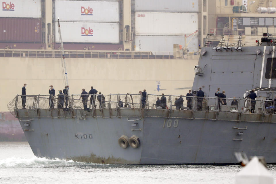 The USS Kidd passes downtown San Diego as it returns to Naval Base San Diego, Tuesday, April 28, 2020, as seen from Coronado, Calif. As the American destroyer heads home with an outbreak in cases of COVID-19, relatives and friends of the 350 crew members prayed for their health while Navy officials vowed to keep the outbreak, the second to strike a Navy vessel at sea, from spreading. (AP Photo/Gregory Bull)