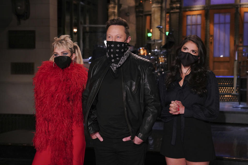 This image released by NBC shows musical guest Miley Cyrus, from left, host Elon Musk, and Cecily Strong during promos in Studio 8H on Thursday, May 6, 2021. (Rosalind O'Connor/NBC via AP)