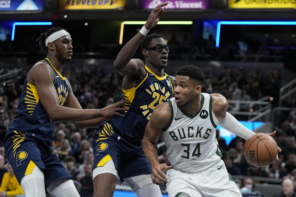 Milwaukee Bucks' Giannis Antetokounmpo (34) goes to the basket against Indiana Pacers' Myles Turner (33) and Jalen Smith (25) during the second half of an NBA basketball game, Wednesday, Jan. 3, 2024, in Indianapolis. (AP Photo/Darron Cummings)