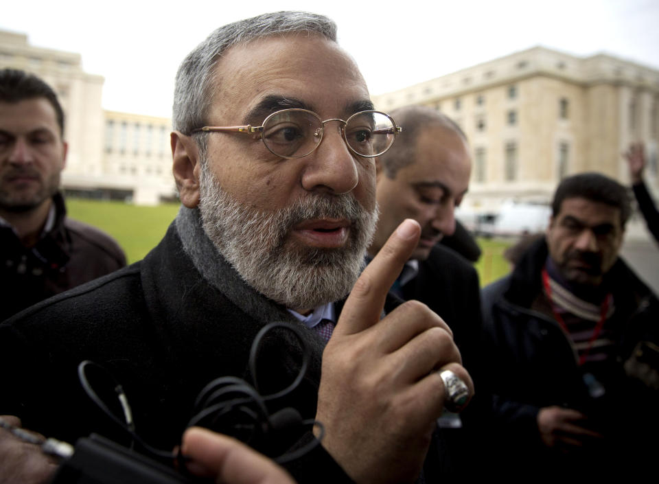 Syrian Information Minister Omran al-Zoubi gestures as he gives a short press briefing upon his arrival to the United Nations headquarters in Geneva, Switzerland, Sunday, Jan. 26, 2014. Syria's government and opposition face each other for the second time Sunday, buffered by a U.N. mediator hoping to guide them to a resolution of the country's devastating civil war. (AP Photo/Anja Niedringhaus)