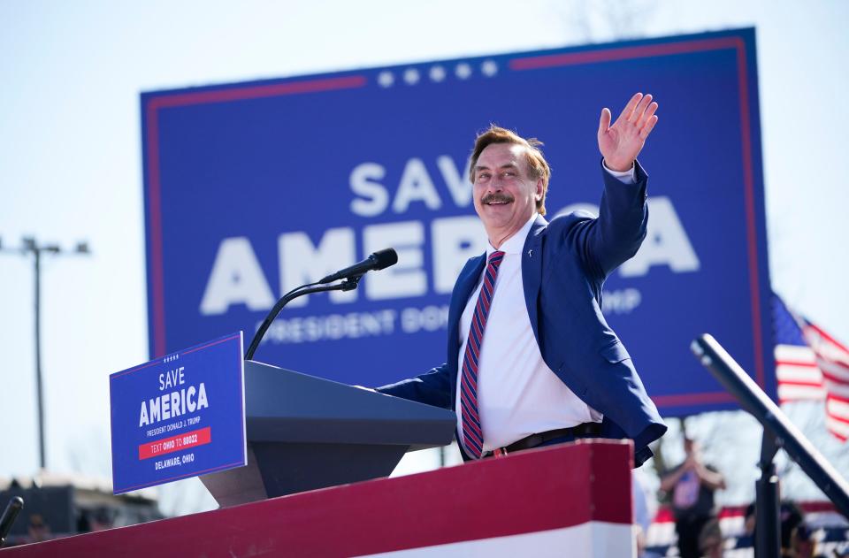 "My Pillow Guy" Mike Lindell waves as he takes the stage during a rally with former President Donald Trump at the Delaware County Fairgrounds in Ohio on April 23, 2022.