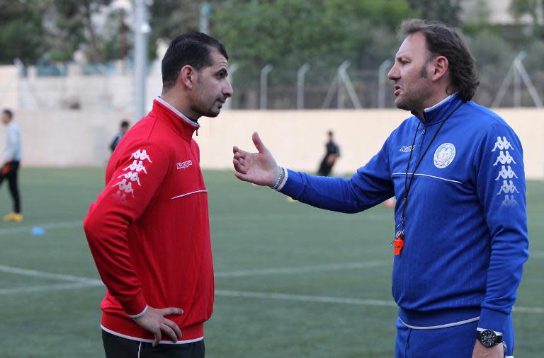 Ahli Al-Khalil football club's coach, Italian Stefano Cusin talks to one of his players during a training session