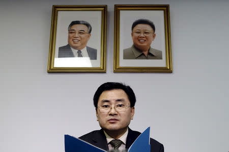 North Korea's new deputy U.N. ambassador An Myong Hun speaks during a news conference in front of portraits of former leader Kim Jong-il (R) and former president Kim Il-sung in New York April 8, 2015. REUTERS/Eduardo Munoz