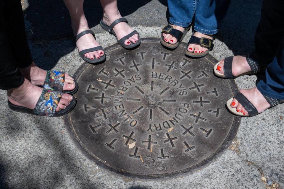 Descendants of the founder of Sacramento’s Berry’s Foundry, Sally Styles Zanotti, Linda Moore, Glory Styles and Katy Styles Rogers, stand around a manhole cover from their great-grandfather’s foundry Tuesday, July 16.