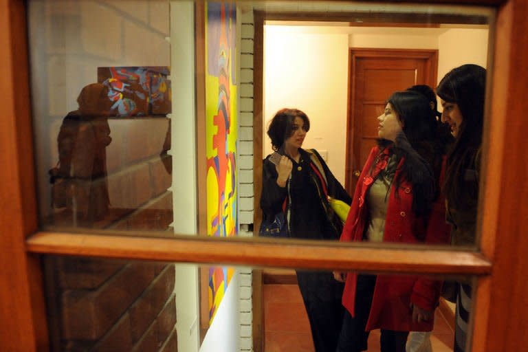 Pakistani visitors look at a painting at the Rohtas Art Gallery in Islamabad, December 12, 2012. Rohtas Gallery was founded in 1981, at the height of military ruler General Zia-ul-Haq's martial law, as Pakistan was undergoing a programme of Islamisation that imposed Draconian restrictions on culture and entertainment