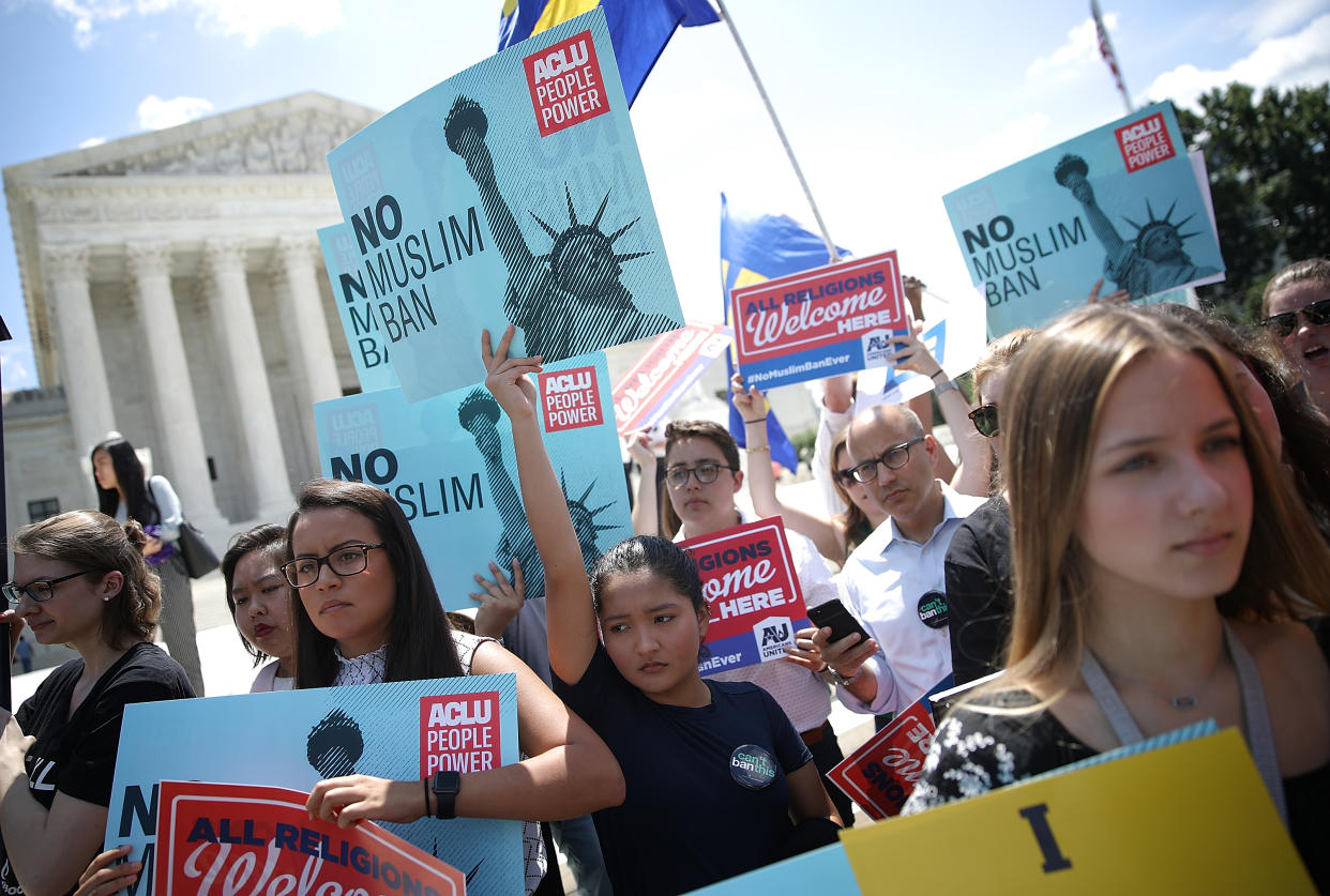 <span class="s1">Protesters rally outside the Supreme Court on Tuesday as justices issue their ruling on President Trump’s travel ban. (Photo: Win McNamee/Getty Images)</span>