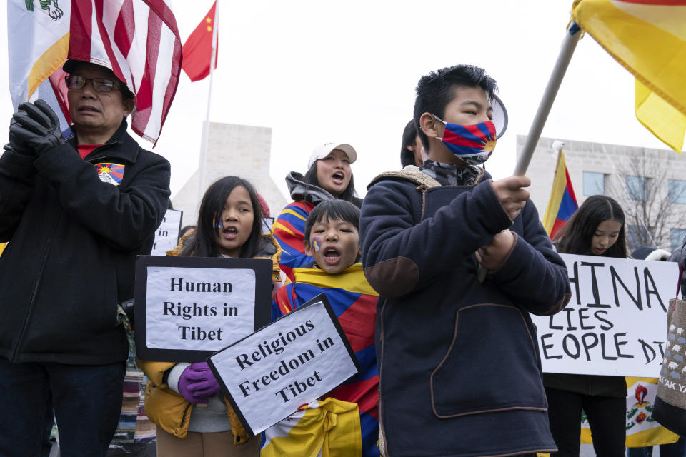 Children hold signs during a rally to commemorate the failed 1959 Tibetan uprising against China's rule, outside of the Chinese Embassy in Washington, Friday, March 10, 2023. The gathering took place on what is known as Tibetan National Uprising Day. (AP Photo/Jose Luis Magana)