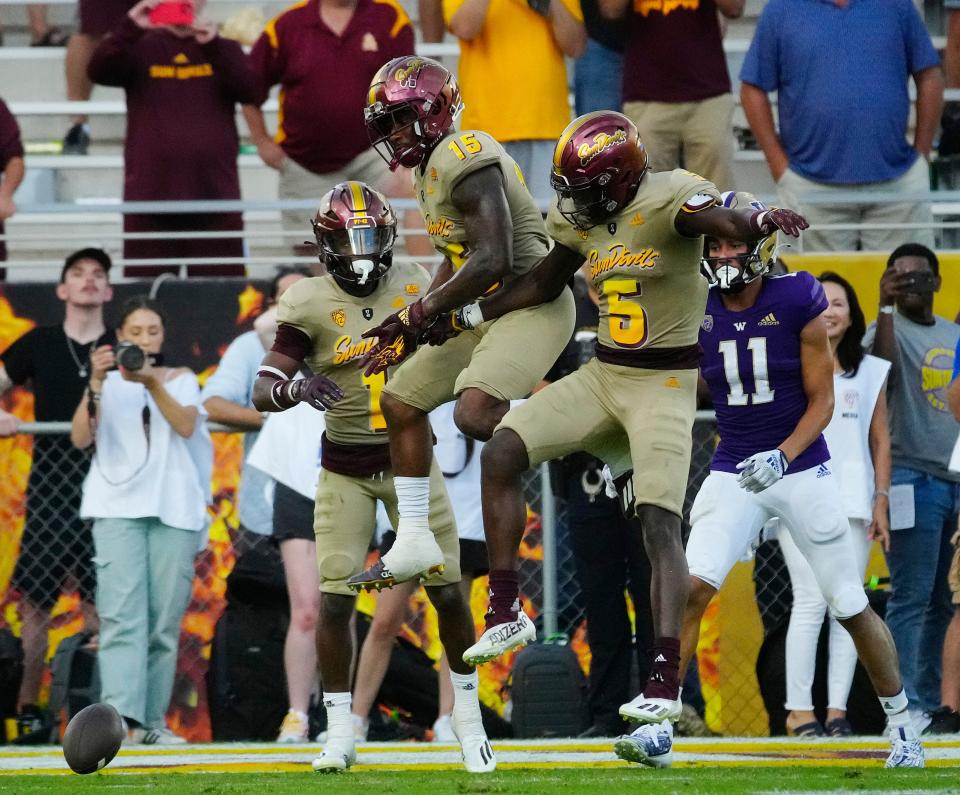 October 8, 2022; Chandler, Ariz; USA; ASU defensive backs Bethley Khoury (15), Chris Edmonds (5) and Jordan Clark (1) celebrate forcing an incompletion on the final play of the game to win 45-38 over Washington at Sun Devil Stadium.