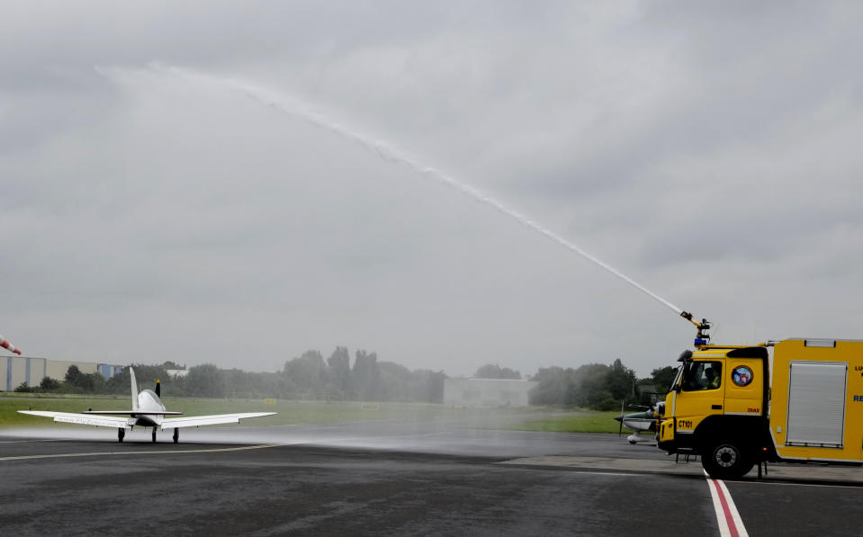 FILE - Belgian-British teenager Zara Rutherford has her plane sprayed with water from a firetruck as she prepares to takes off at the Kortrijk-Wevelgem airfield in Wevelgem, Belgium, Aug. 18, 2021. Rutherford is set to land in Kortrijk, Belgium on Monday, Jan. 17, 2022, in the hopes of completing her trek around the world as the youngest woman ever, beating the mark of American aviator Shaesta Waiz, who was 30 when she set the previous benchmark. (AP Photo/Virginia Mayo, File)