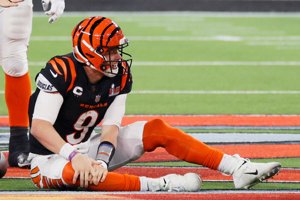 INGLEWOOD, CALIFORNIA - FEBRUARY 13: Joe Burrow #9 of the Cincinnati Bengals holds his knee following a play during the second half of Super Bowl LVI against the Los Angeles Rams at SoFi Stadium on February 13, 2022 in Inglewood, California. (Photo by Steph Chambers/Getty Images)