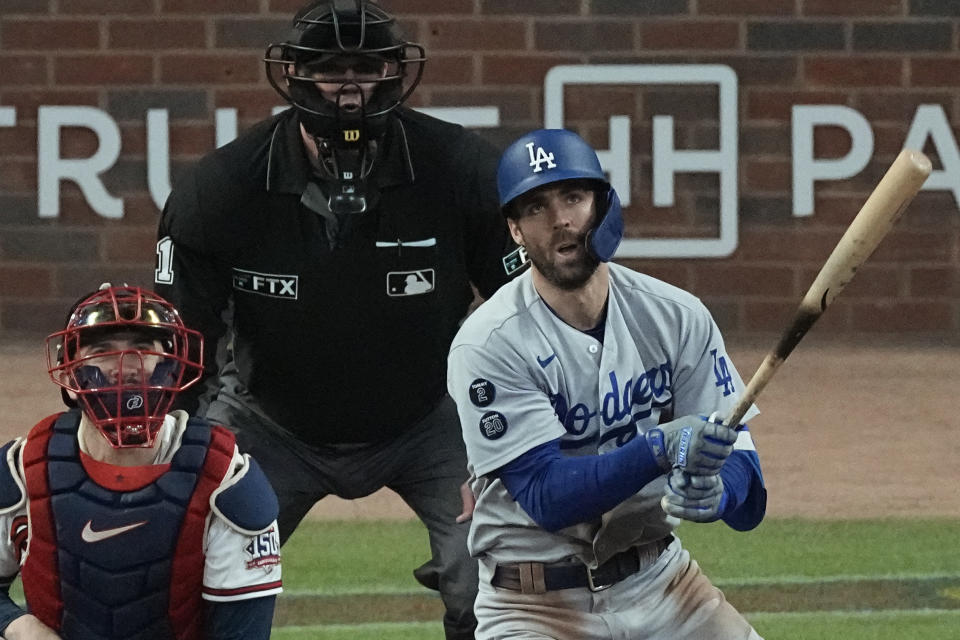 Los Angeles Dodgers' Chris Taylor watches his hit for a two-run double during the seventh inning against the Atlanta Braves in Game 2 of baseball's National League Championship Series Sunday, Oct. 17, 2021, in Atlanta. (AP Photo/John Bazemore)