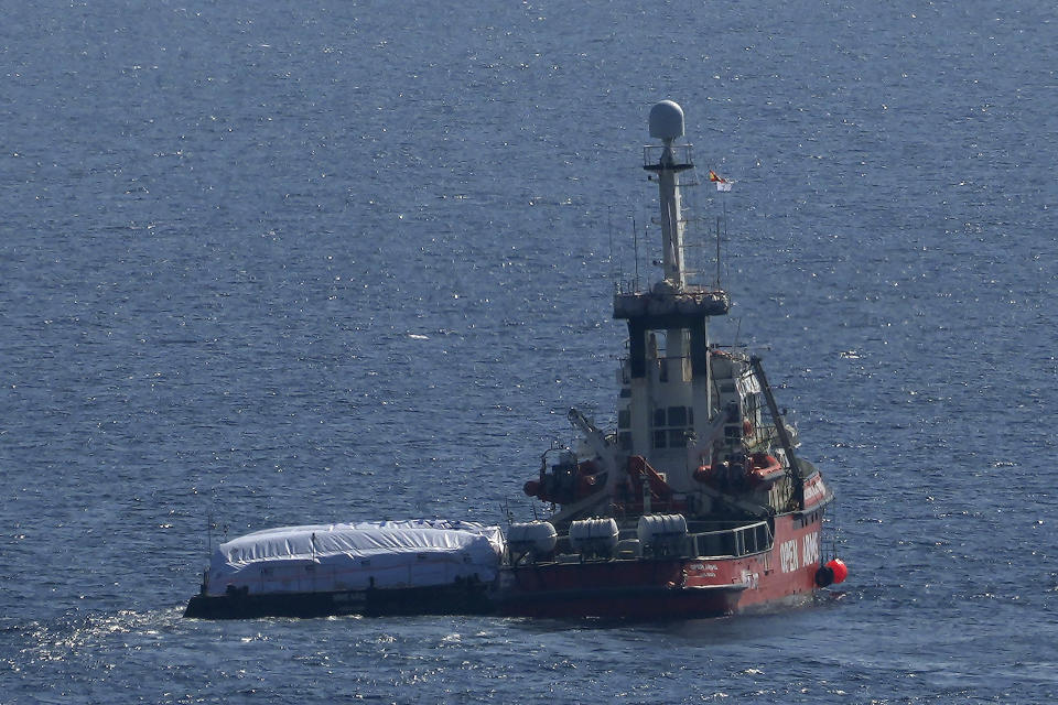 The ship belonging to the Open Arms aid group with aid on a platform ferry some 200 tonnes of rice and flour directly to Gaza, departs from the port from southern city of Larnaca, Cyprus, Tuesday, March 12, 2024. An aid ship loaded with some 200 tons of food set sail Tuesday from Cyprus to Gaza, the international charity behind the effort said. The shipment is a test for the opening of a sea corridor to supply aid to the territory, where starvation is spreading five months into the Israel-Hamas war. (AP Photo/Petros Karadjias)