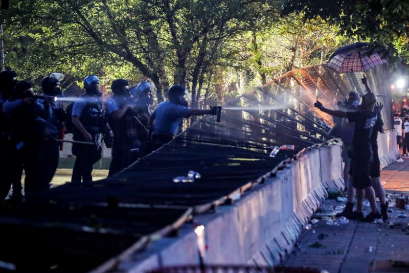 FILE PHOTO: Riot police utilize pepper spray on protesters as demonstrations continue in Minneapolis