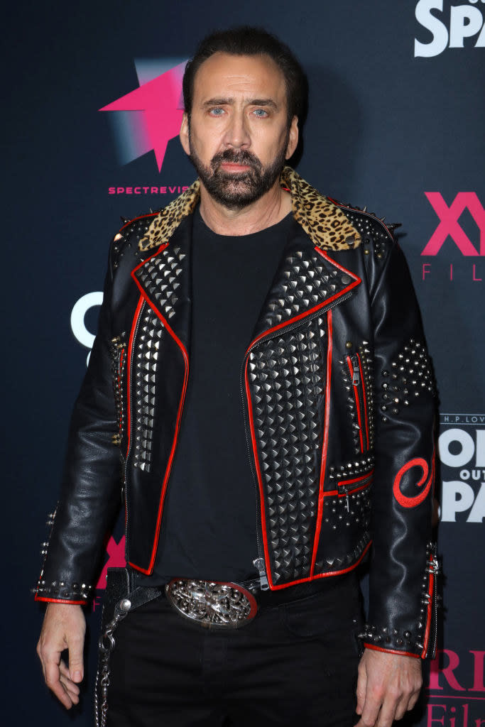Nicolas wearing a studded leather jacket at a red carpet event