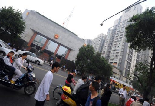 Motorists and pedestrians are seen passing the Chengdu People's Intermediate court in Chengdu, in southwest China's Sichuan province, on September 18, where Wang Lijun, an ex-police chief who triggered the Chinese Communist party's biggest scandal in years, was being tried. Judgement in the case of Wang will be given Monday, a court official told AFP