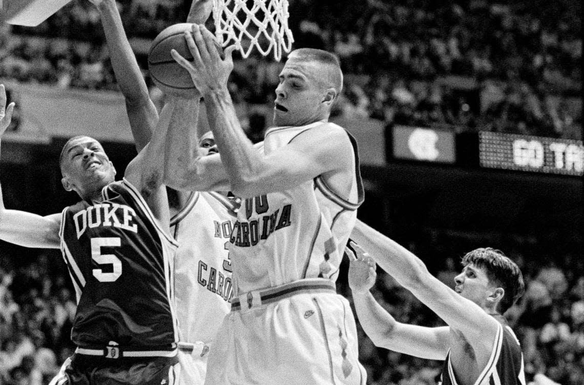 UNC center Eric Montross rips down a rebound against Duke’s Jeff Capel and Cherokee Parks.