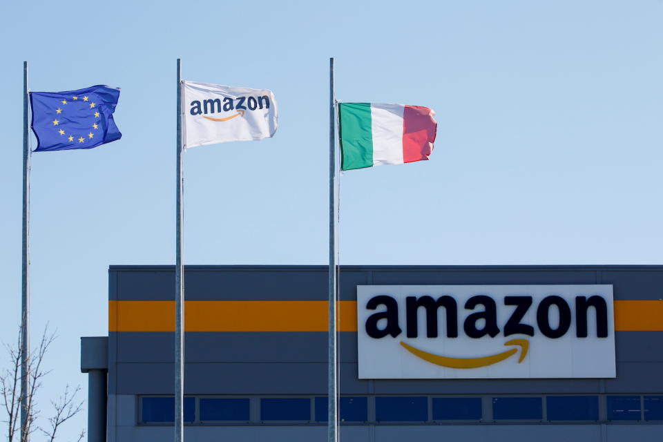 Flags flutter outside a distribution centre, during a strike at Amazon's logistics operations in Italy, in Passo Corese, Italy March 22, 2021. REUTERS/Remo Casilli - RC29GM9RNZZG