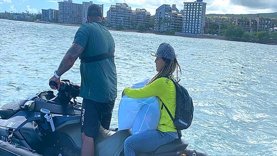 PHOTO: A Pacific Birth Collective volunteer boards a jet ski to take baby supplies to families in need after the Maui wildfires. (Pacific Birth Collective)