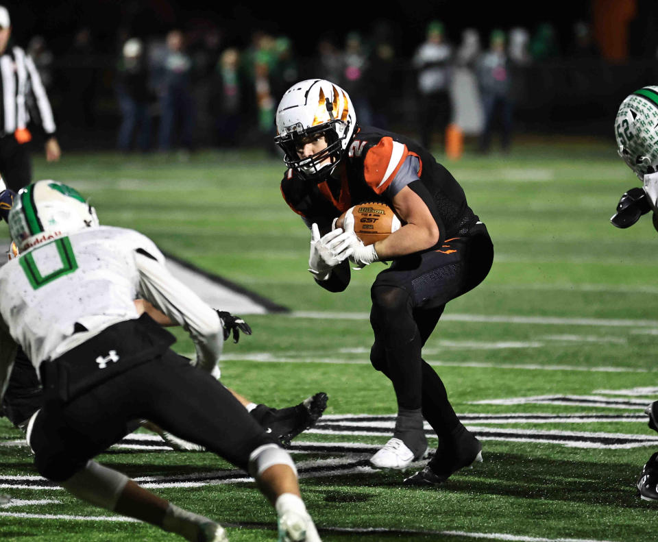 Anderson running back Brodey Berg (2) runs the ball during their playoff win over Harrison Friday, Nov. 10, 2023.